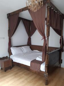 a bedroom with a four poster bed with a canopy at Casa Silvia in Constanţa