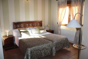 a bedroom with a large bed and a window at Finca Rincón de la Vega in Los Cortos