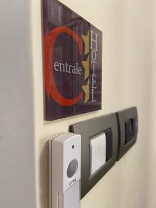 an emergency exit sign on a door with a thermostropheropheropheropherophe at Hotel Centrale in Trieste
