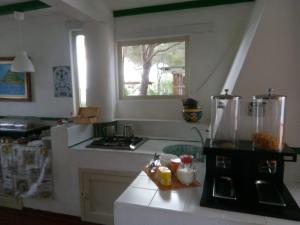 a kitchen with a stove and a window in it at Villa Saracina in Vulcano