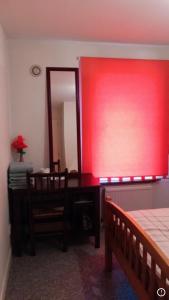 a bedroom with a red window and a mirror at Comfy Home in Aberdeen