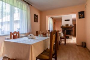 a room with a table with a white table cloth on it at Agroturystyka u Julii in Helusz