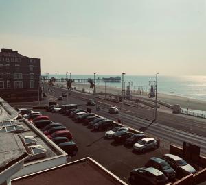 a parking lot with cars parked next to the beach at Canasta Hotel in Blackpool