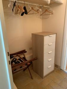a closet with a dresser and a shelf with shoes at Il Pozzetto Home Resort in Pietrasanta