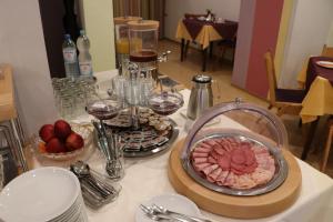 a table with a plate of food on a table at Hotel Regina in Darmstadt