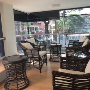 a group of chairs and tables in a restaurant at Hotel Ruiseñor Itagui in Itagüí