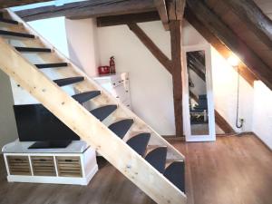 a loft conversion with a staircase and a tv at Appartement 1856 in Landsberg am Lech