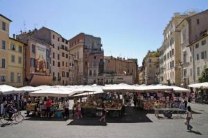 a market in a city with white umbrellas at CARTARI9 home in Rome
