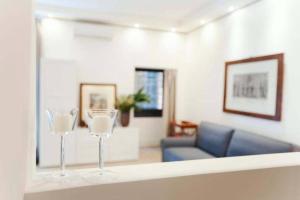two wine glasses sitting on a counter in a living room at CARTARI9 home in Rome