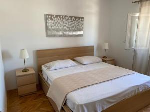 Postel nebo postele na pokoji v ubytování Apartments Barbaresko