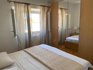Postel nebo postele na pokoji v ubytování Apartments Barbaresko
