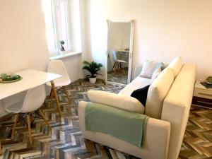 a living room with a couch and a table at Greta's place - Elegant home with Exclusive location and Seaview in Izola