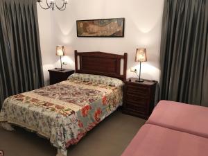 a bedroom with a bed and two night stands at Casa Campo in Abay