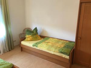 ein kleines Bett mit zwei Kissen darauf in einem Zimmer in der Unterkunft Zollern-Alb Aktiv in Albstadt