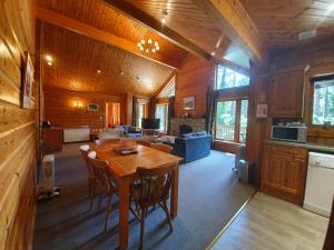 a kitchen and living room with a table in a cabin at The Dorset Resort in East Stoke