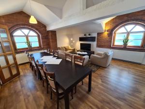 a living room with a table and chairs and a couch at Hotel Staropolska in Tomaszów Lubelski