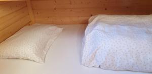 a bed with two pillows on top of it at Prachtig Scandinavisch Chalet in Makkum