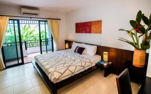 a bedroom with a bed and a balcony at Sang Serene House in Chiang Mai