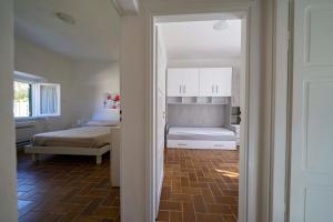 a room with a bedroom with a bed and a door at CASA SAN ROCCO in Porto Ercole