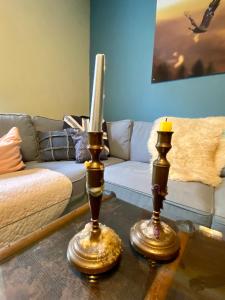 a living room with a couch and a candle on a table at Alte Schule 2 in Kall