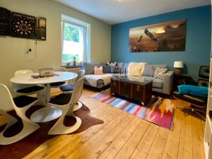 a living room with a table and a couch at Alte Schule 2 in Kall