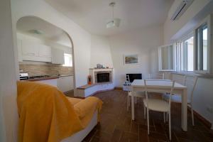 a living room with a table and a kitchen with a tableablish at CASA SAN ROCCO in Porto Ercole