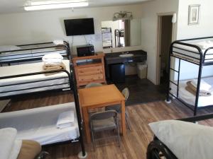a dorm room with a desk and bunk beds at Whitney Portal Hotel And Hostel in Lone Pine