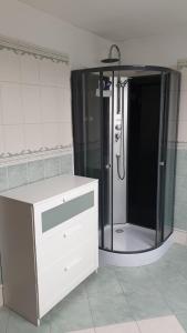 a bathroom with a shower and a white dresser at Le basecamp des sommets in Stavelot +12 photos