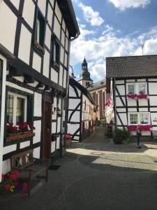 a woman walking down a street in a town at Ferienapartment: An Der Kunstakademie Heimbach in Heimbach