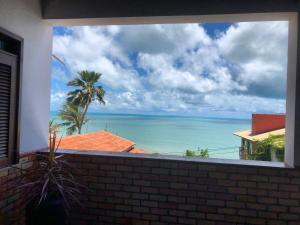 uma vista para o oceano a partir de uma janela em Pousada do Holandês em Canoa Quebrada