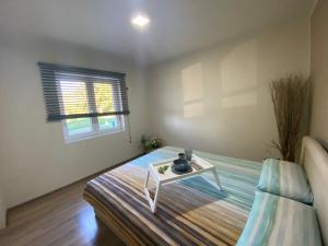 a bedroom with a bed with a table on it at Vila Novaković in Kladovo