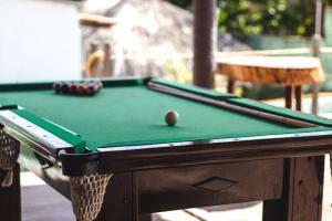 a pool table with a cue ball on top of it at POUSADA TEIXEIRA in Barreirinhas