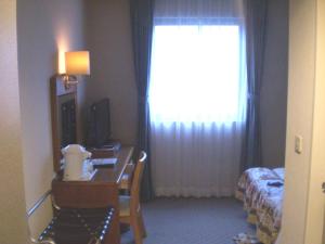 Una cama o camas en una habitación de Shingu UI Hotel