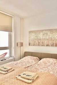 a bedroom with two beds and a painting on the wall at Ramonda Residences - New Belgrade in Belgrade