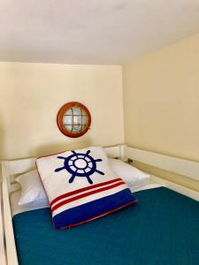 a small room with a bed with a pillow with a ship at LA SUITE ENCHANTÉE Disneyland Paris in Serris