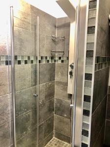 a shower with a glass door in a bathroom at LA SUITE ENCHANTÉE Disneyland Paris in Serris