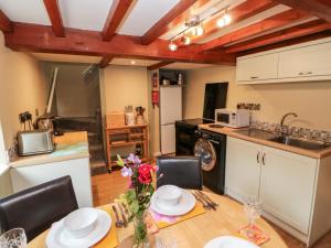 a kitchen and dining room with a table and chairs at Margaret's Cottage in Feetham +25 photos