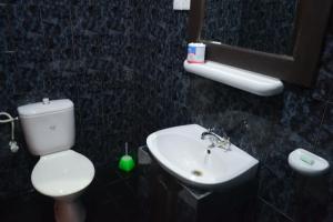 a bathroom with a white toilet and a sink at Hotel Thai Lanka in Hikkaduwa
