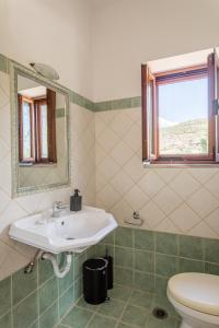 a bathroom with a sink and a toilet at Chioureas apartments in Levktron +19 photos