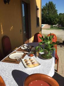 a table with a plate of food on top of it at Il Casale di Lavinia in Fabro