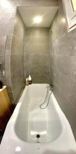 a large white bath tub in a bathroom at Les Falaises in 'Aïn Taya