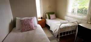 a small room with two beds and a window at Regent Residential Villa in Whangarei
