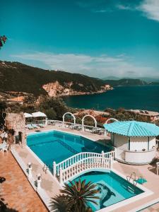 a swimming pool with a view of the ocean at Dolphin Apartments 1 in Parga