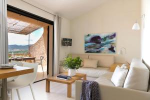 a living room with a white couch and a table at Domaine Santa Giulia Palace in Porto-Vecchio