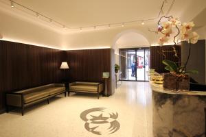 a hotel lobby with a couch and a table at Hotel Fenice in Milan