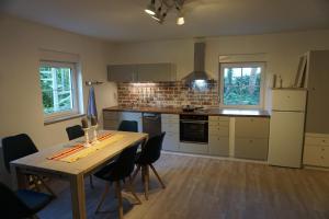 a kitchen with a table and chairs in a room at FW An der Roth in Roth