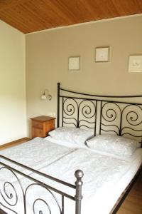 a bedroom with a large bed with white sheets at Gut Tausendbachl in Regen