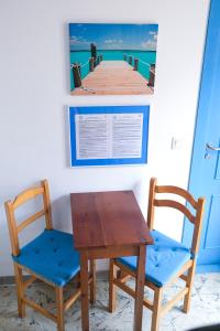 a table and two chairs next to a pier at Mana Mana Youth Hostel in Tossa de Mar