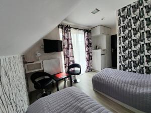 ヤスタルニャにあるParadiseのベッドルーム1室(ベッド2台、デスク、テレビ付)