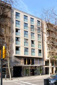 a building with a hotel on the side of a street at Evenia Rocafort in Barcelona